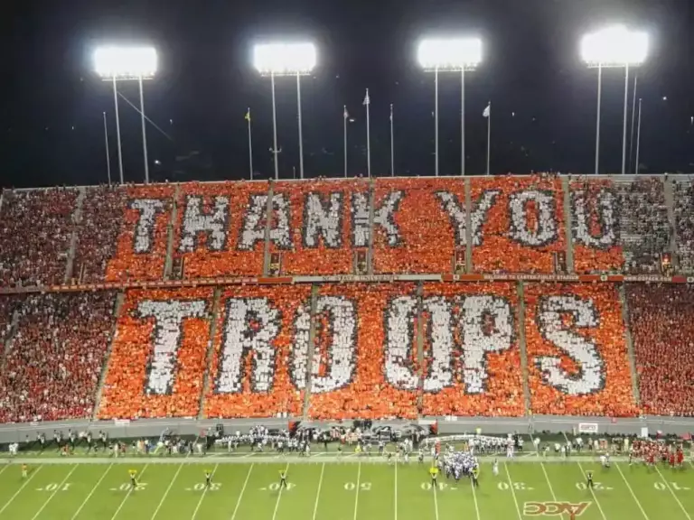 military bowl in annapolis; shot of crowd holding sign to spell our thank you troops; events in annapolis