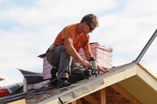 Roofer putting shingles on the roof of a home; roofing 101